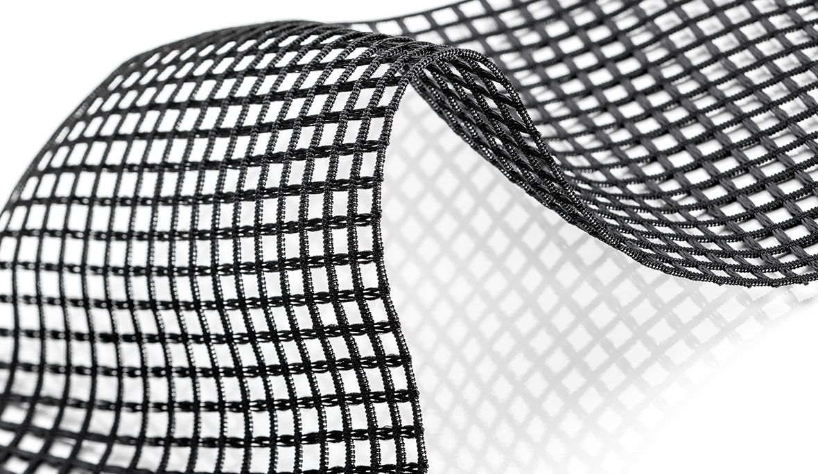 Raschelnetzband: Nahaufnahme eines elastischen Webband-Netzes in Schwarz vor weißem Hintergrund.